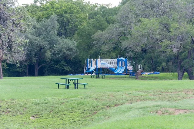 a garden with trees and wooden fence