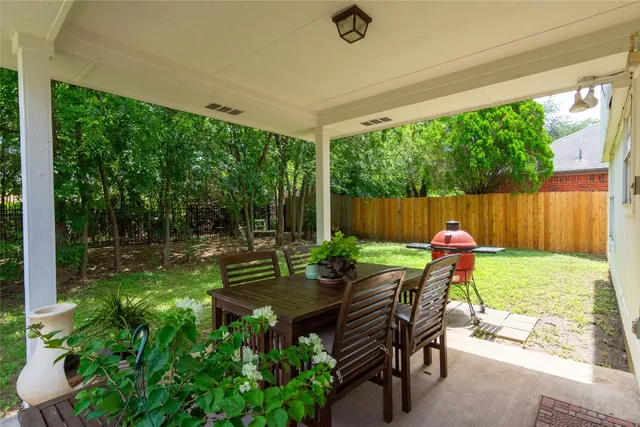 a view of a chair and tables in the backyard
