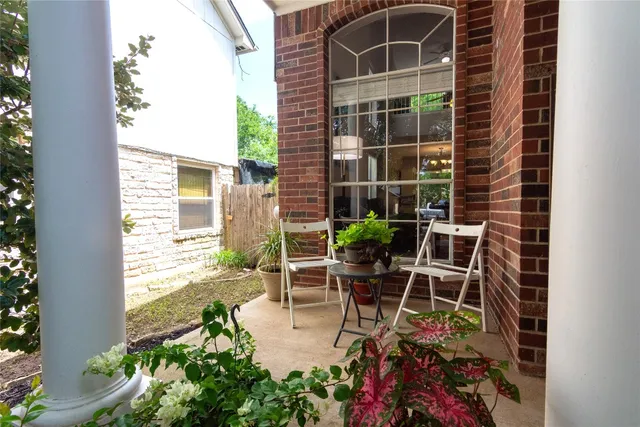 a view of a chair and table in backyard of the house