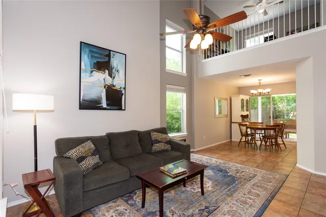 a living room with furniture a table and a chandelier