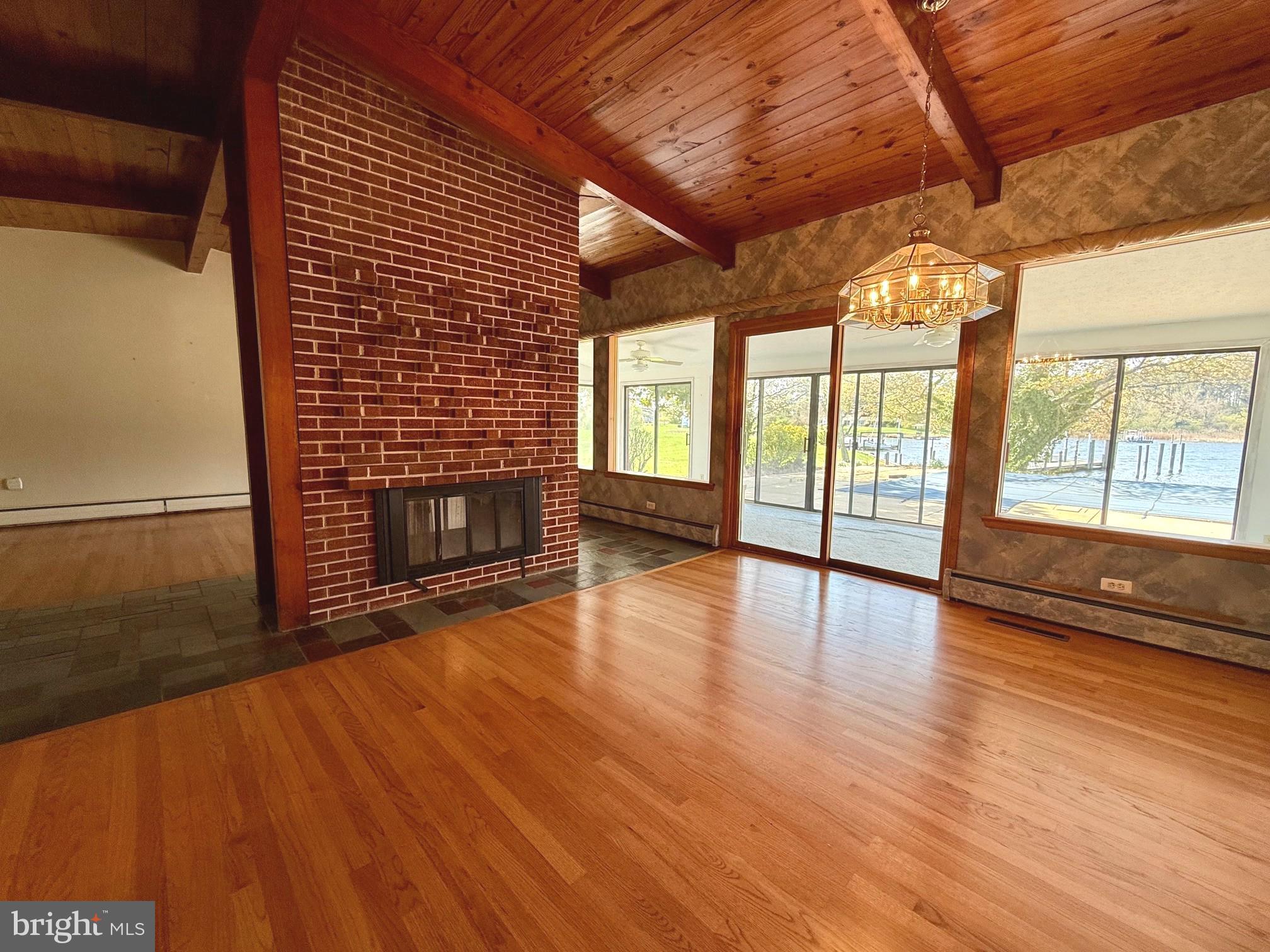 48607 Deep Cove Lane Ridge, MD 20680 - Photo 11 of 47 a view of an empty room with wooden floor and a window
