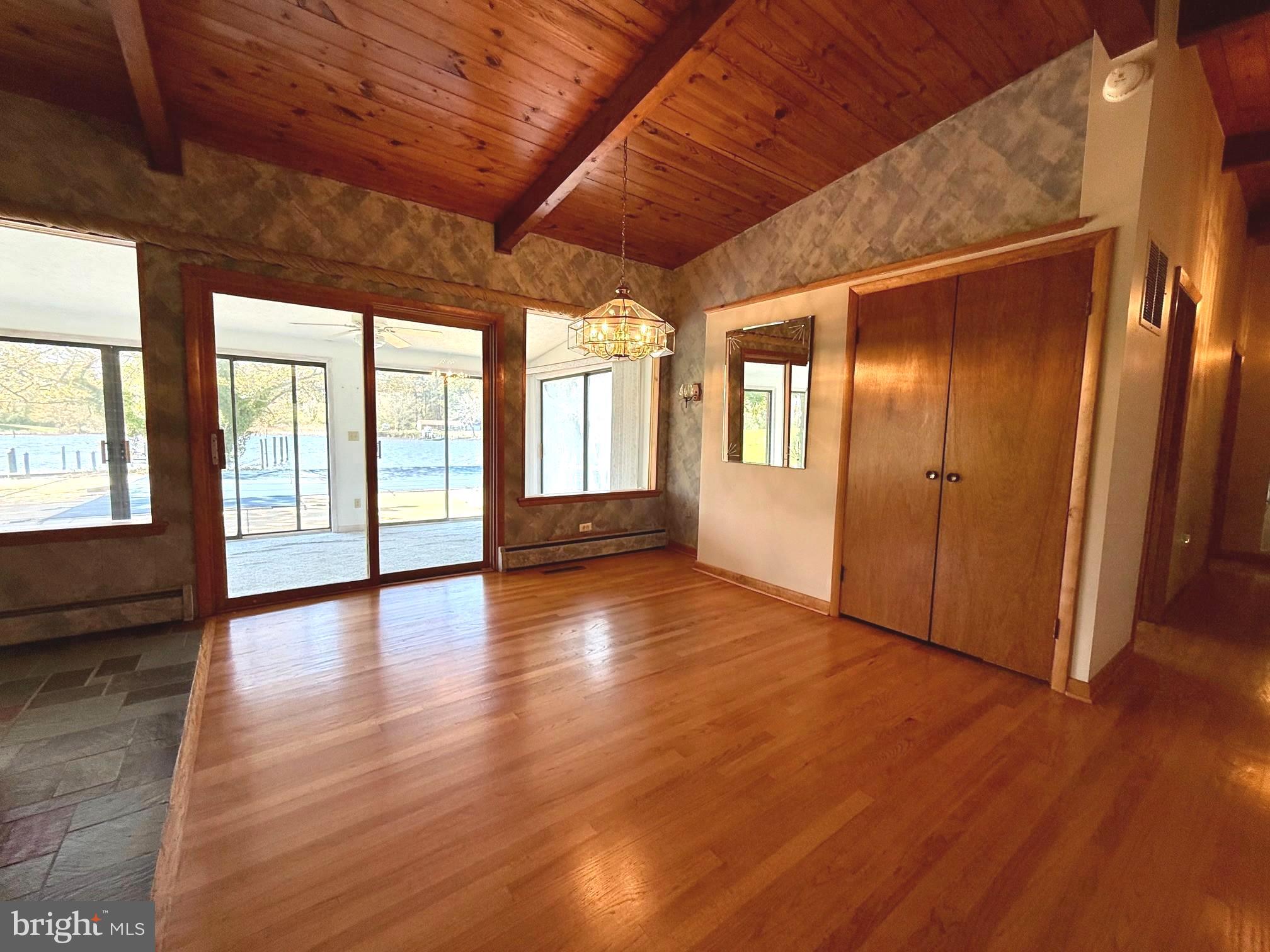 48607 Deep Cove Lane Ridge, MD 20680 - Photo 13 of 47 a view of an empty room with wooden floor and a window