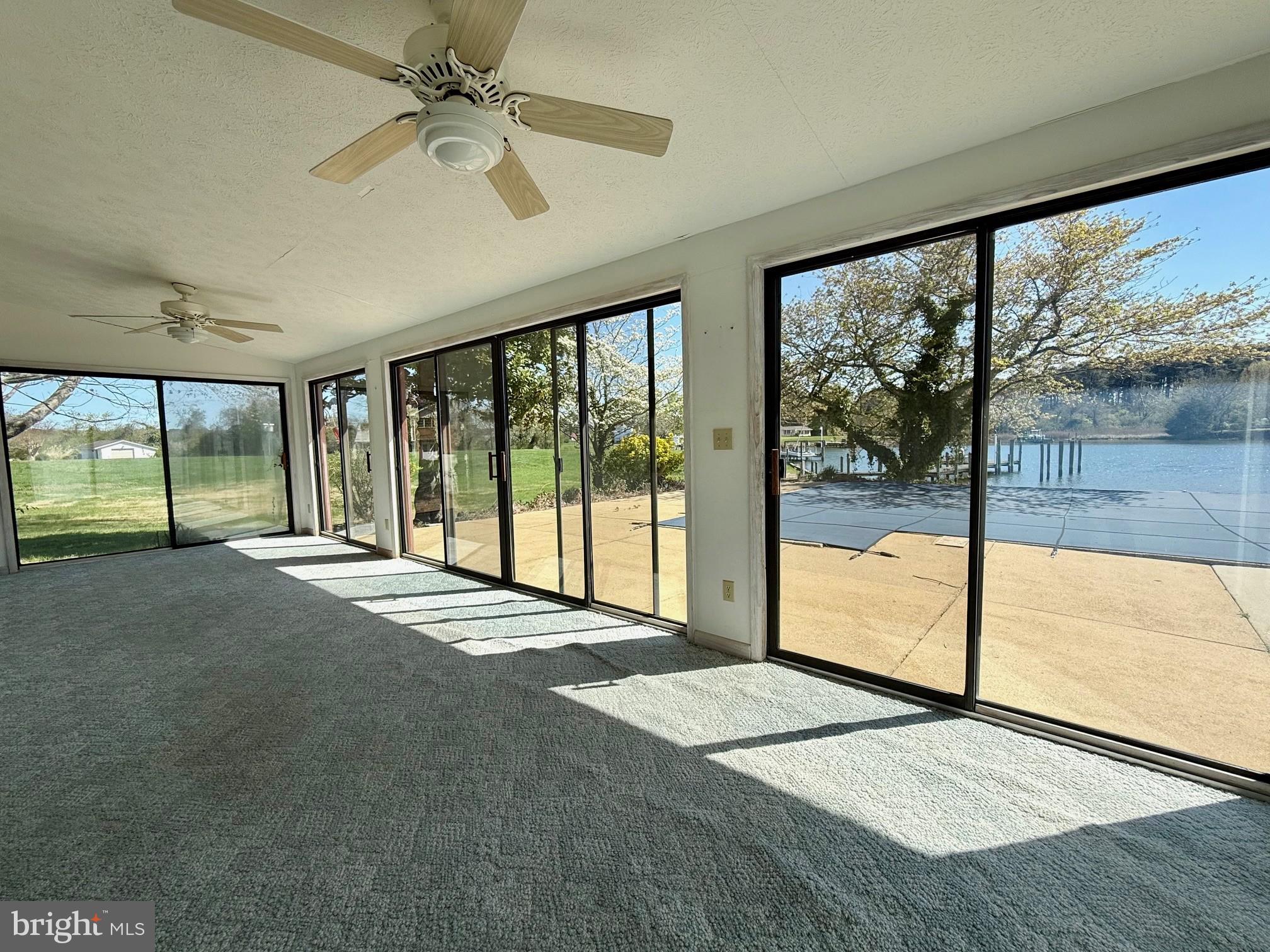 48607 Deep Cove Lane Ridge, MD 20680 - Photo 15 of 47 a view of an empty room with a large window with kitchen view