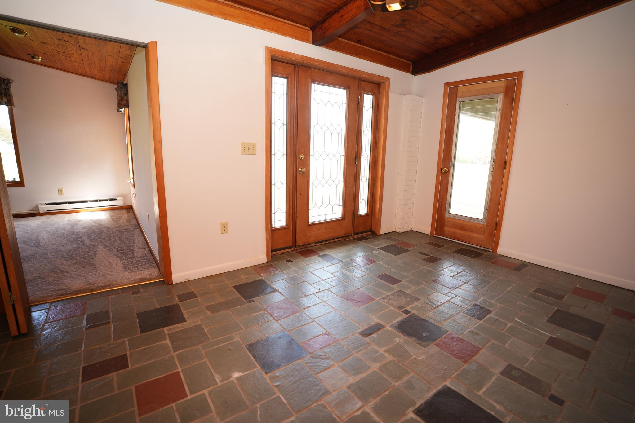 48607 Deep Cove Lane Ridge, MD 20680 - Photo 17 of 47 an empty room with wooden floor and windows
