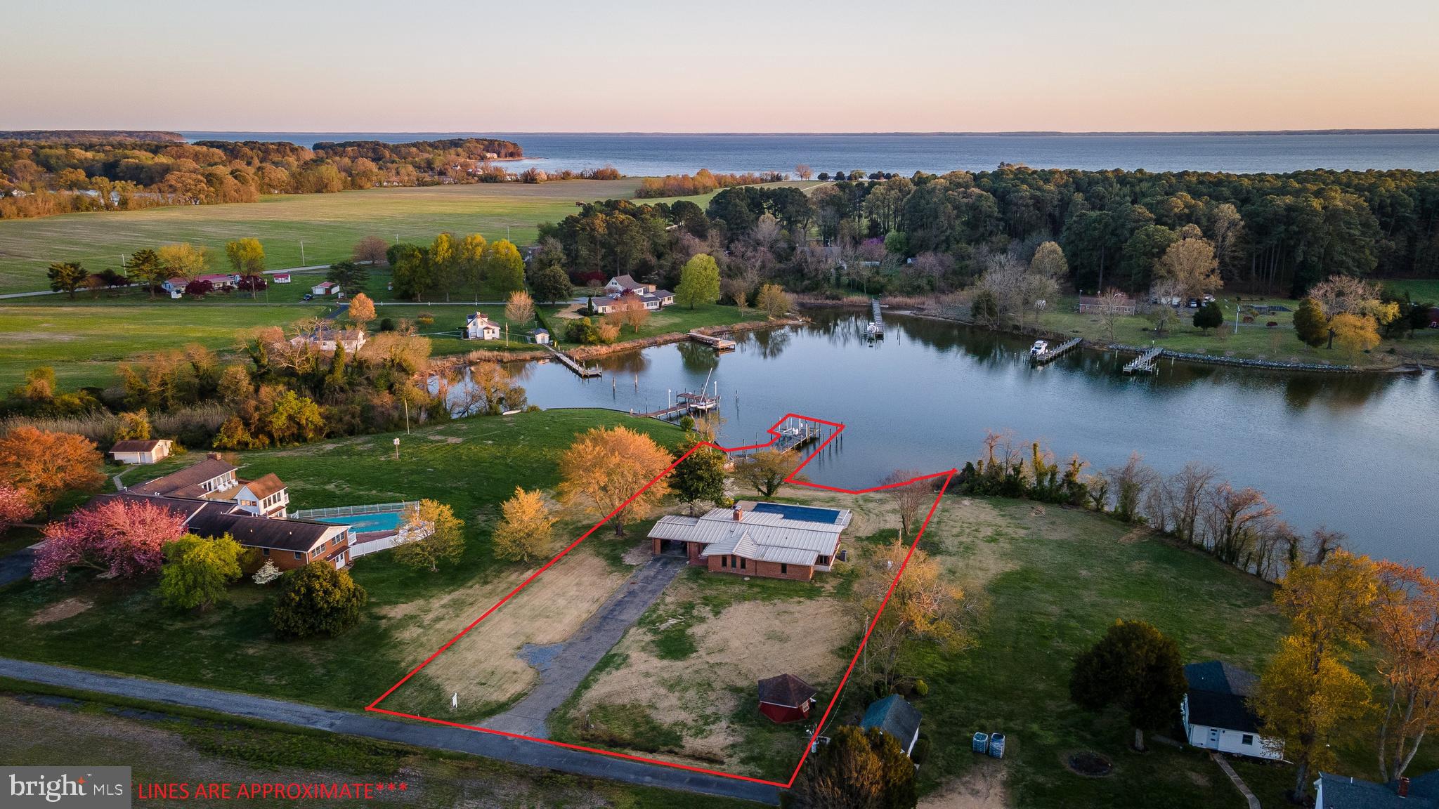 48607 Deep Cove Lane Ridge, MD 20680 - Photo 2 of 47 an aerial view of a town with swimming pool and mountains