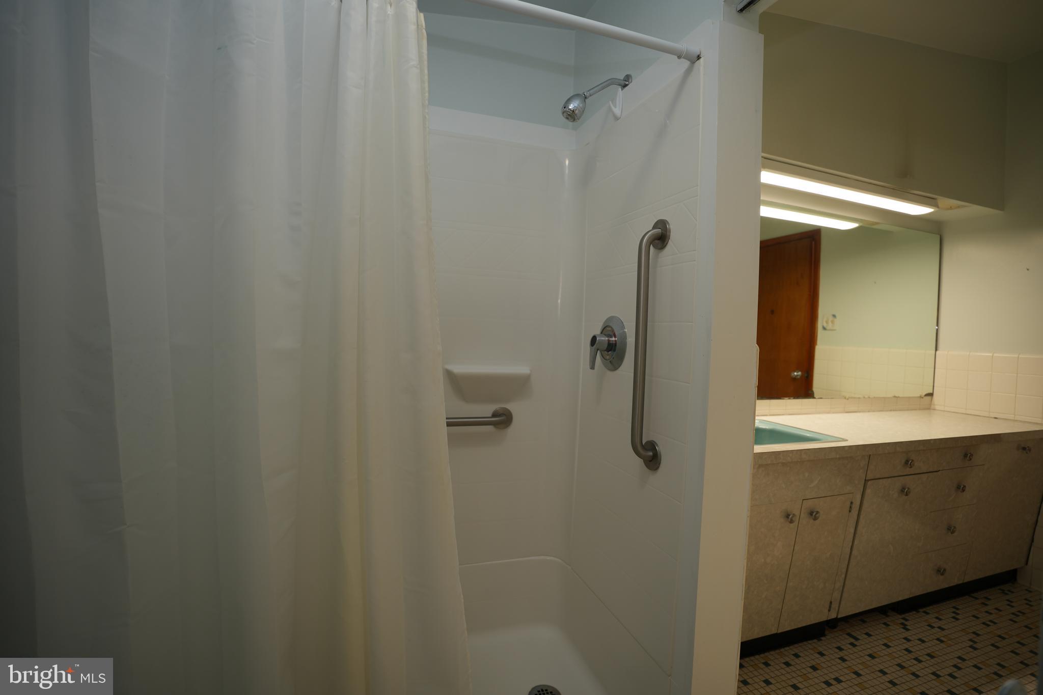 48607 Deep Cove Lane Ridge, MD 20680 - Photo 33 of 47 a bathroom with a shower and a sink