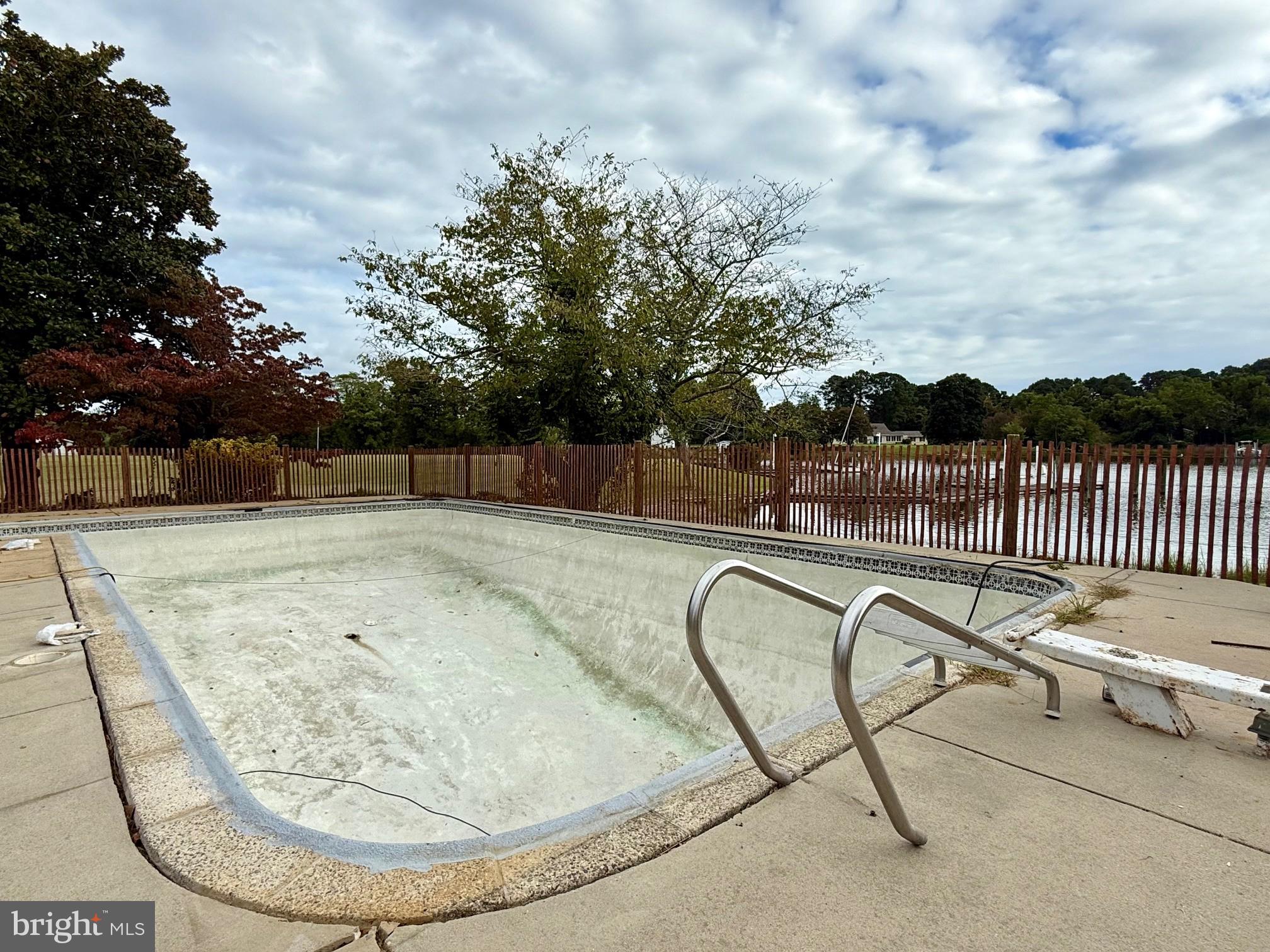 48607 Deep Cove Lane Ridge, MD 20680 - Photo 37 of 47 a view of a swimming pool with a lounge chair