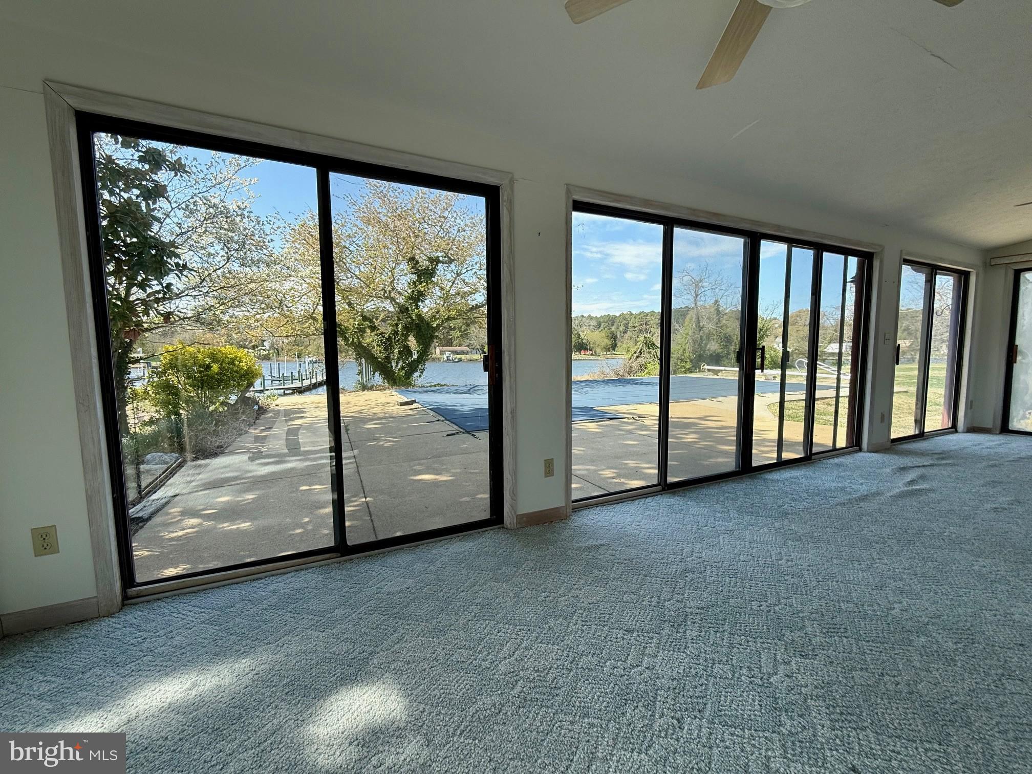 48607 Deep Cove Lane Ridge, MD 20680 - Photo 10 of 47 a view of a big room with large windows