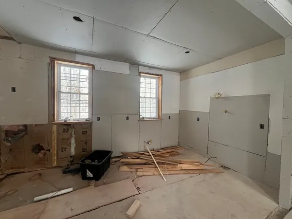 a spacious bedroom with a bed and a window