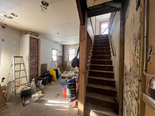 a view of a livingroom with furniture and staircase