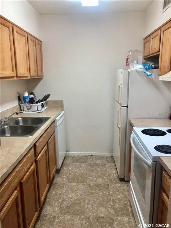 a kitchen with a sink stove and cabinets
