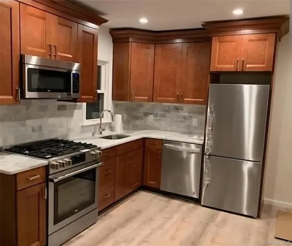 a kitchen with stainless steel appliances granite countertop a refrigerator stove and microwave