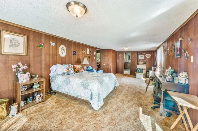 a bed room with a bed and a chair