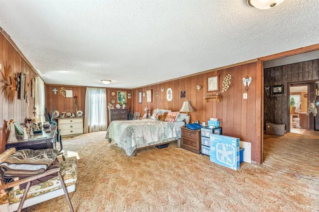 a spacious bedroom with a large bed and a couch