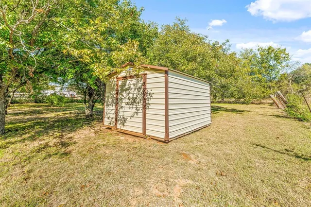 a view of a house with a yard and garage