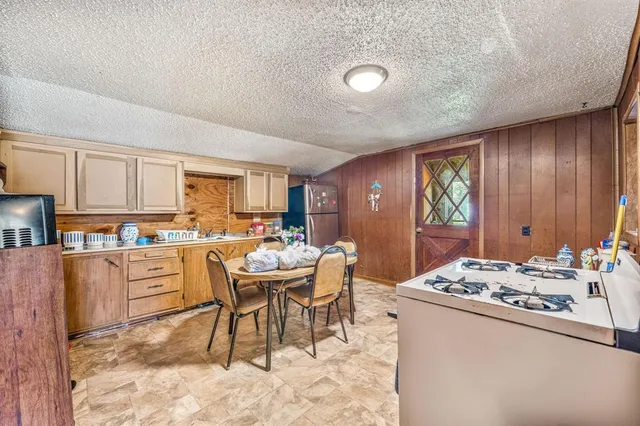 a kitchen with a sink stove and view living room