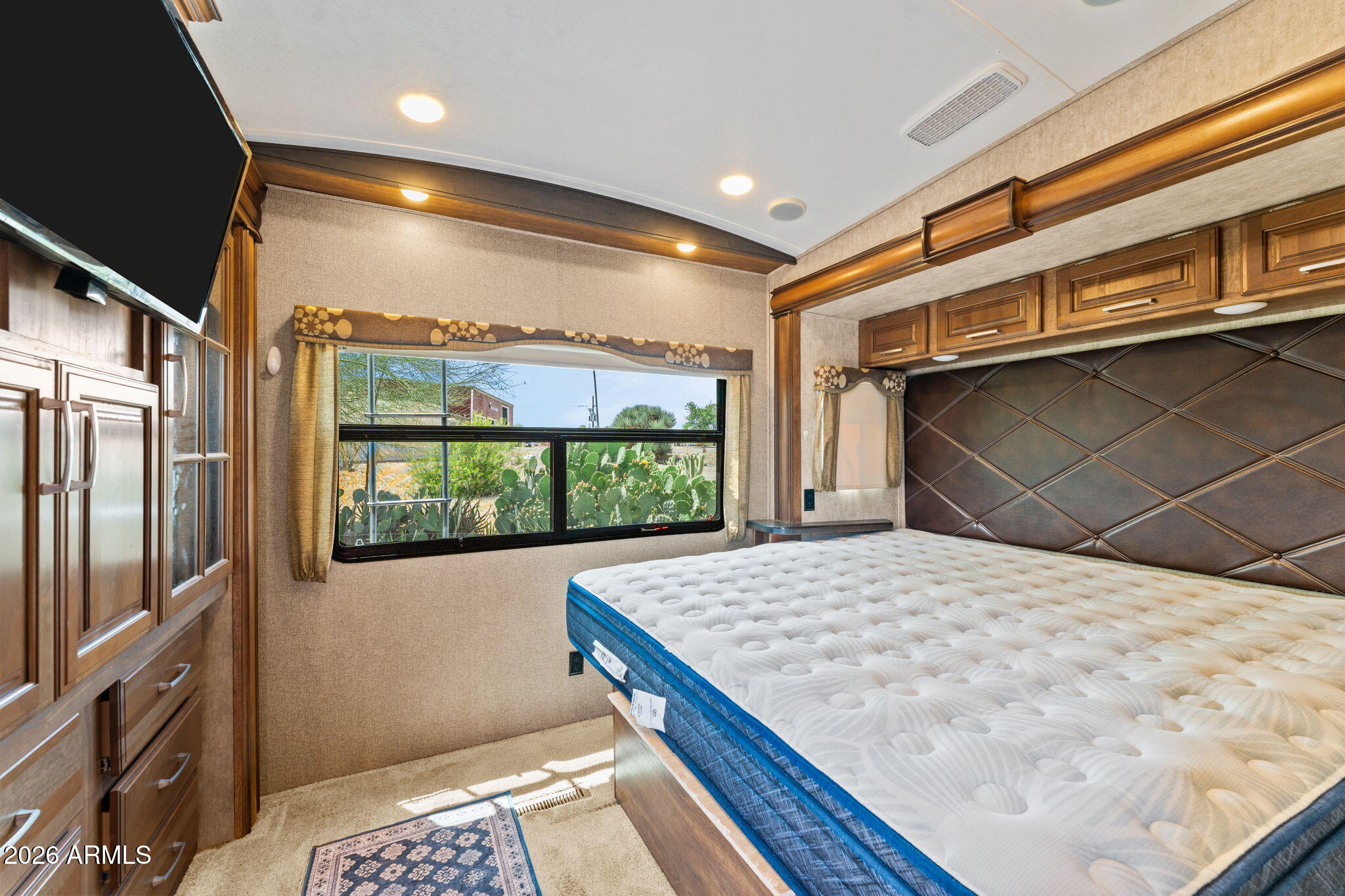 30770 South Pioneer Pass Road, Unit 393 Congress, AZ 85332 - Photo 14 of 23 a bedroom with a bed and a dresser next to a window