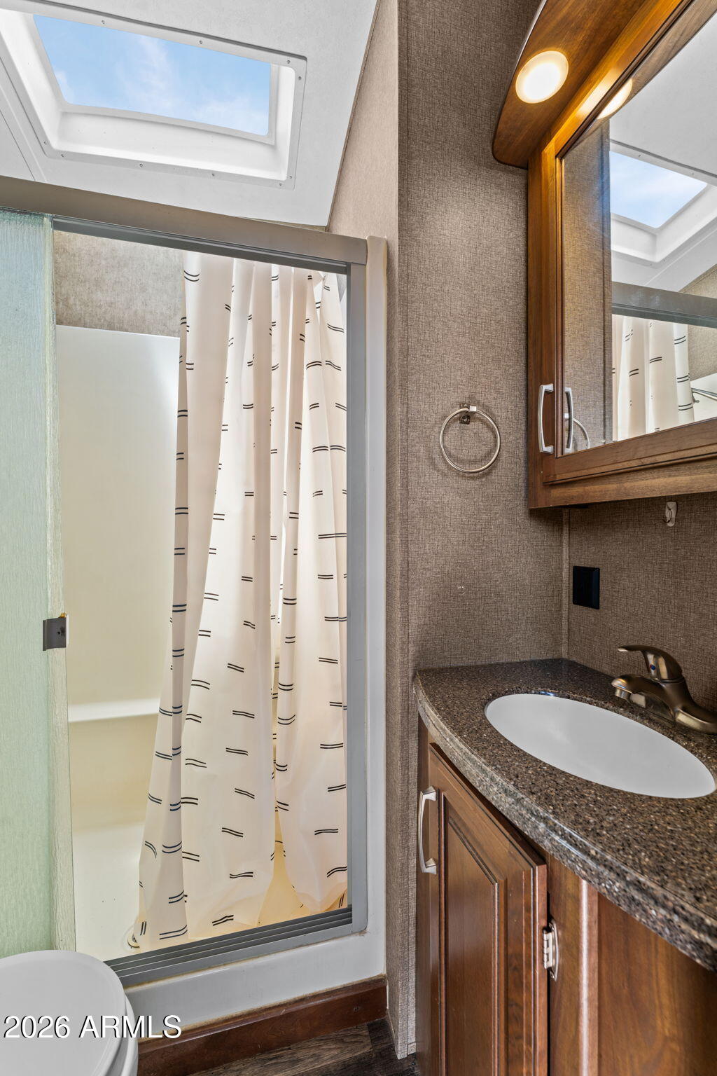 30770 South Pioneer Pass Road, Unit 393 Congress, AZ 85332 - Photo 16 of 23 a bathroom with a granite countertop sink a mirror and a shower