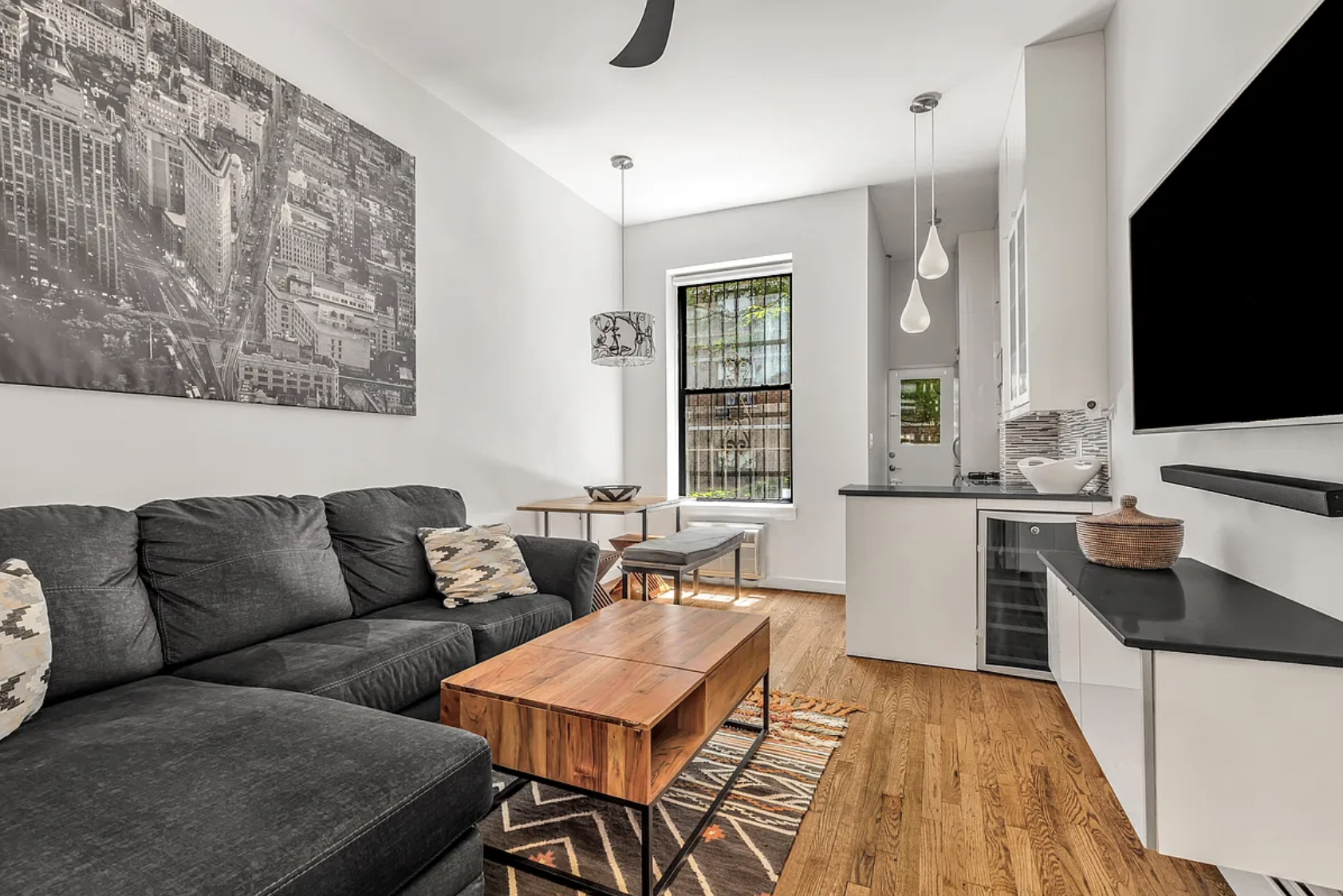 424 East 77th Street, Unit 1D Manhattan, NY 10075 - Photo 3 of 8 a living room with furniture and a flat screen tv