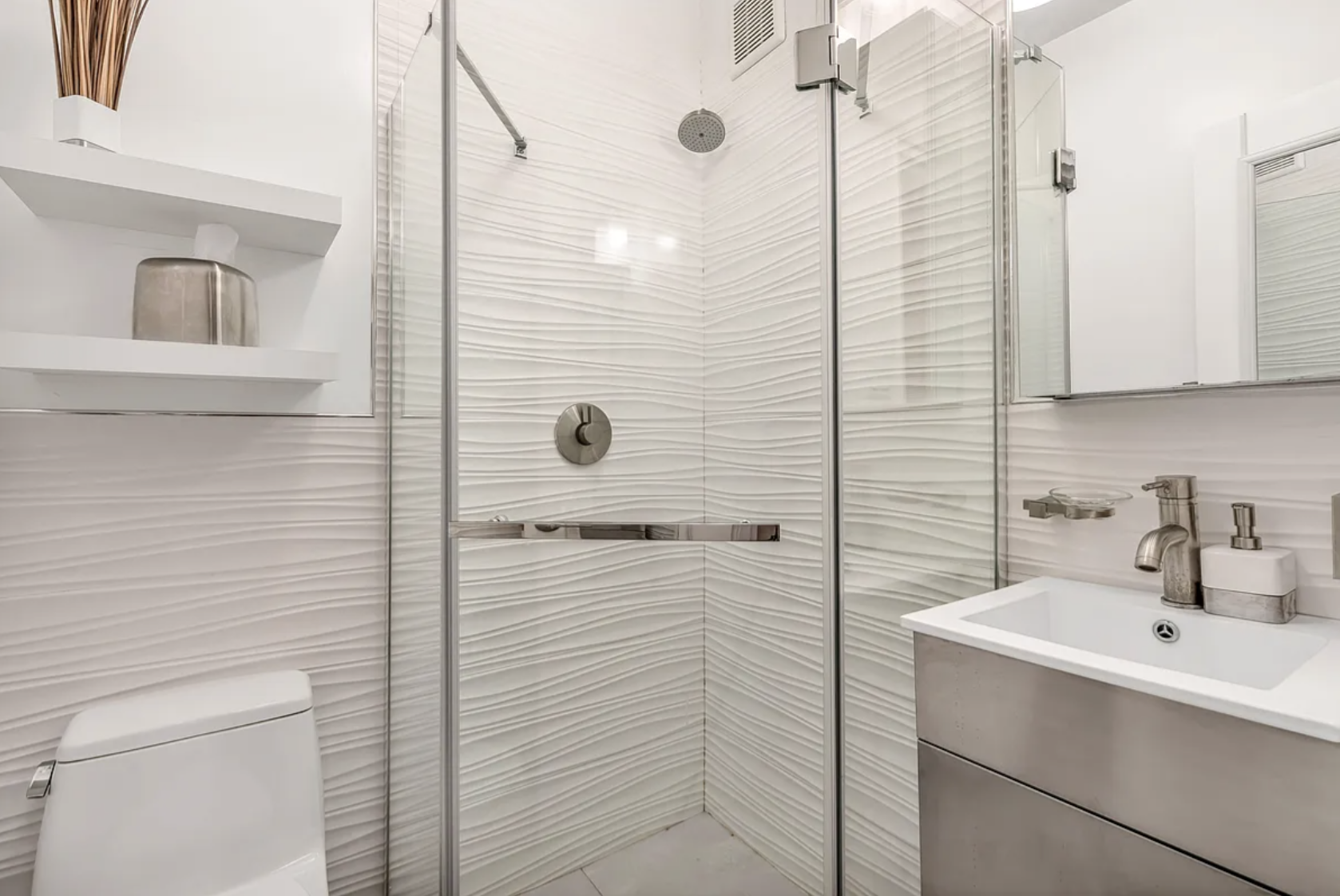 424 East 77th Street, Unit 1D Manhattan, NY 10075 - Photo 7 of 8 a bathroom with a sink a mirror and shower