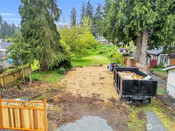 a backyard of a house with yard and outdoor seating