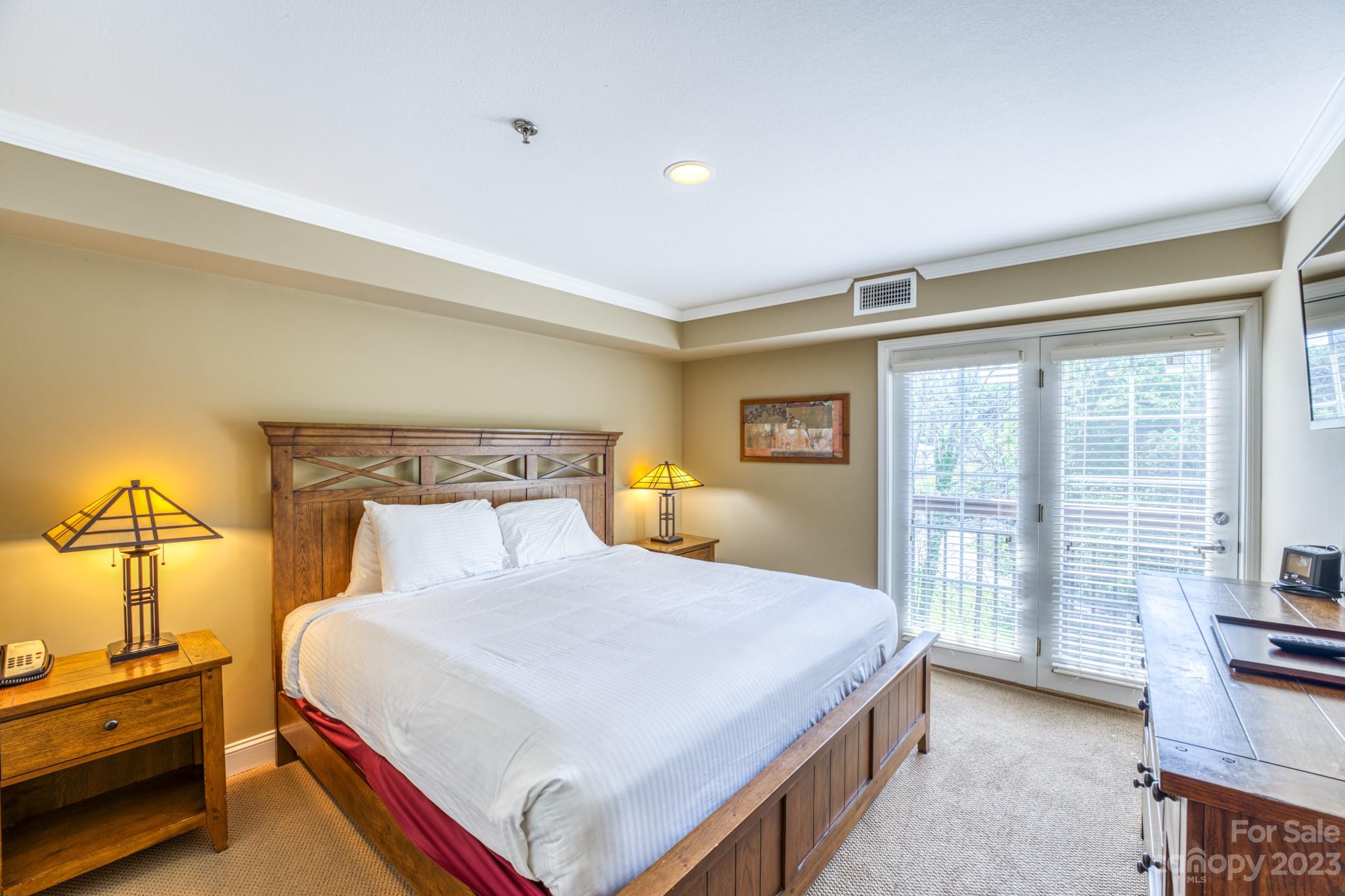 310 Bowling Park Road Asheville, NC 28803 - Photo 11 of 31 a bedroom with a bed and a large window