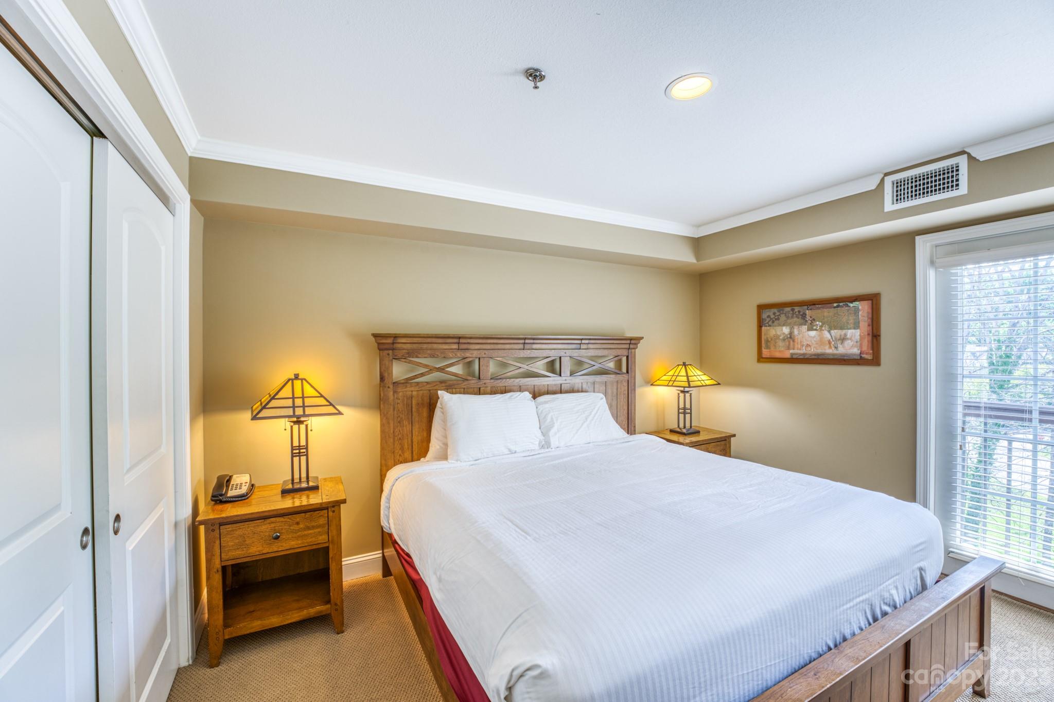 310 Bowling Park Road Asheville, NC 28803 - Photo 12 of 31 a bedroom with a bed and wooden floor