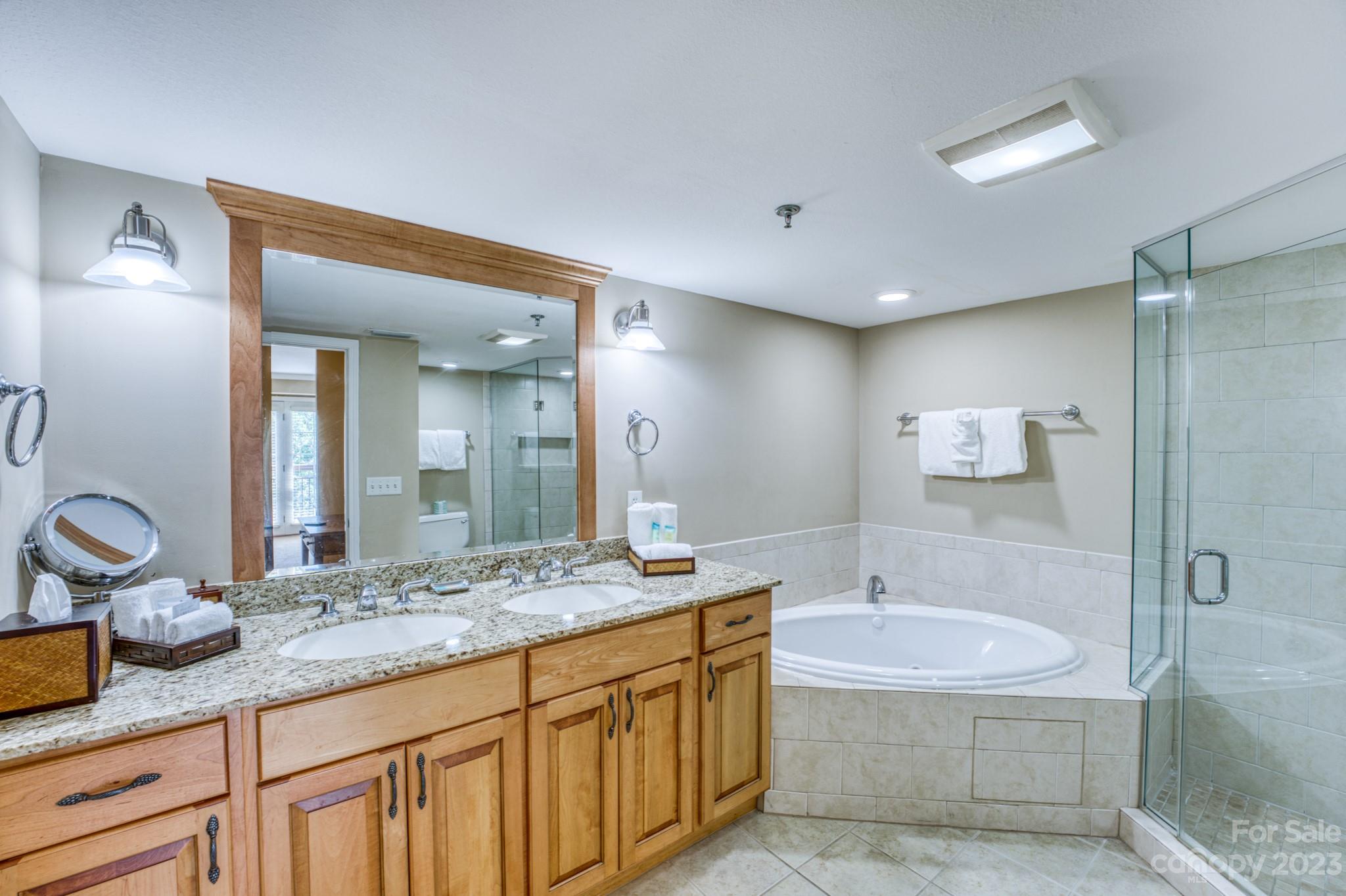 310 Bowling Park Road Asheville, NC 28803 - Photo 13 of 31 a bathroom with a granite countertop sink mirror and bathtub