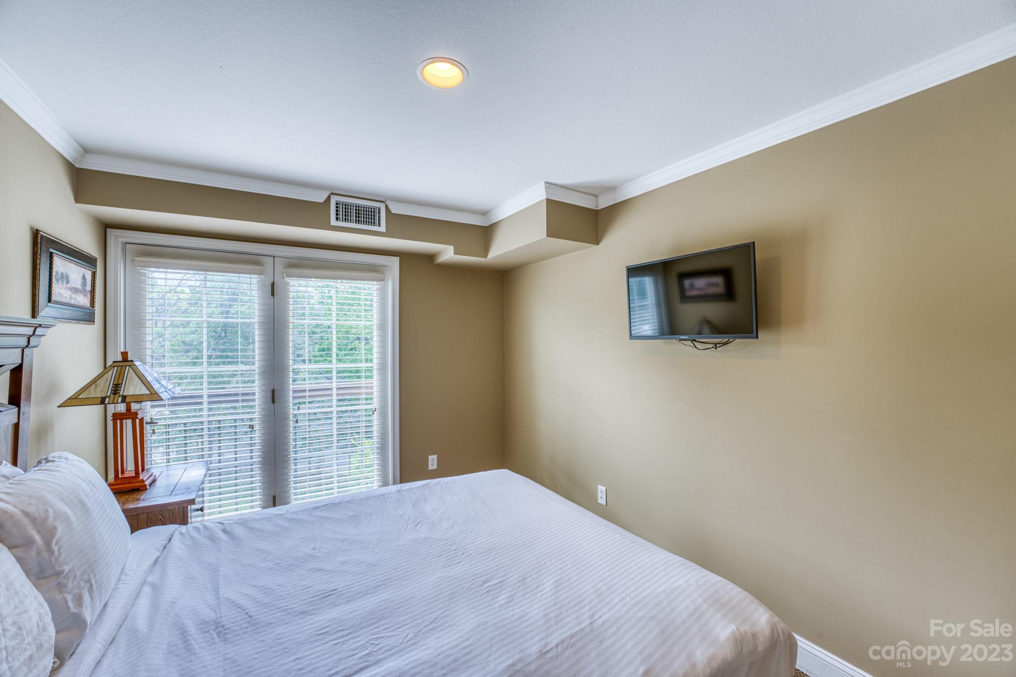 310 Bowling Park Road Asheville, NC 28803 - Photo 15 of 31 a bedroom with a bed and wooden floor