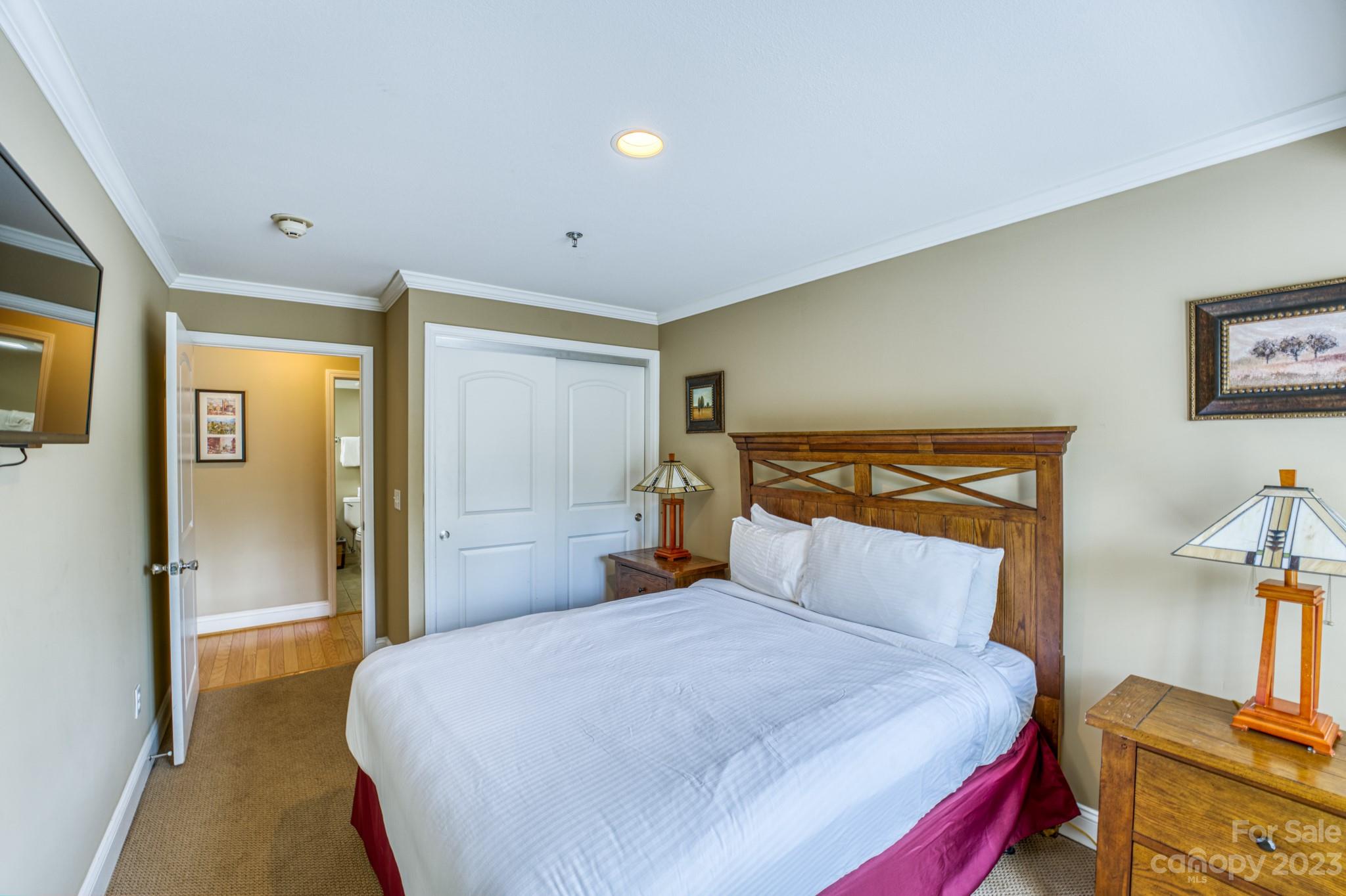 310 Bowling Park Road Asheville, NC 28803 - Photo 16 of 31 a bedroom with a bed and wooden floor