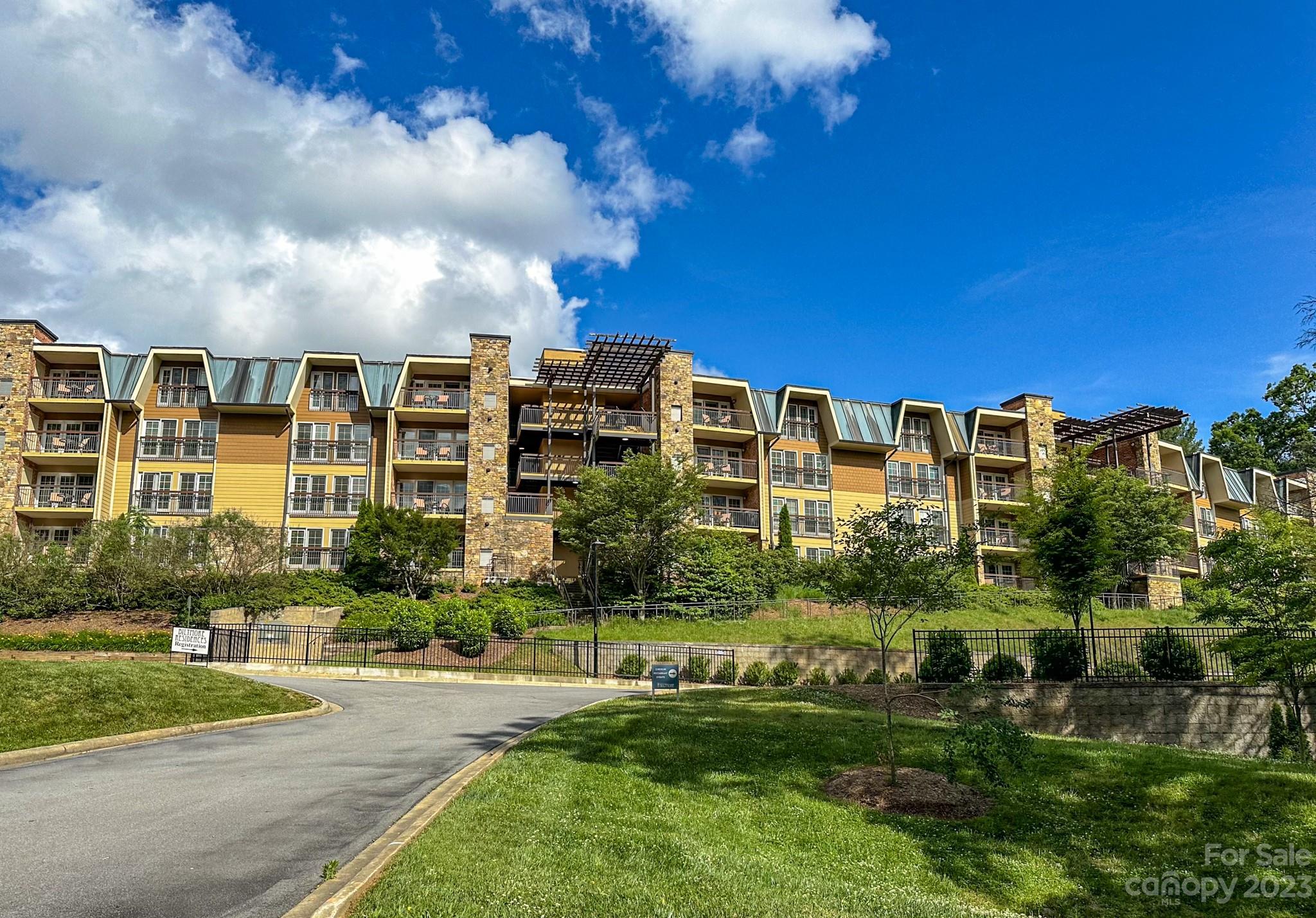 310 Bowling Park Road Asheville, NC 28803 - Photo 28 of 31 a view of a large building with a yard