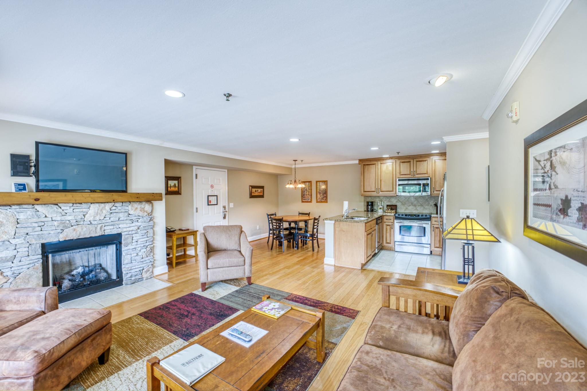 310 Bowling Park Road Asheville, NC 28803 - Photo 5 of 31 a living room with furniture and a fireplace