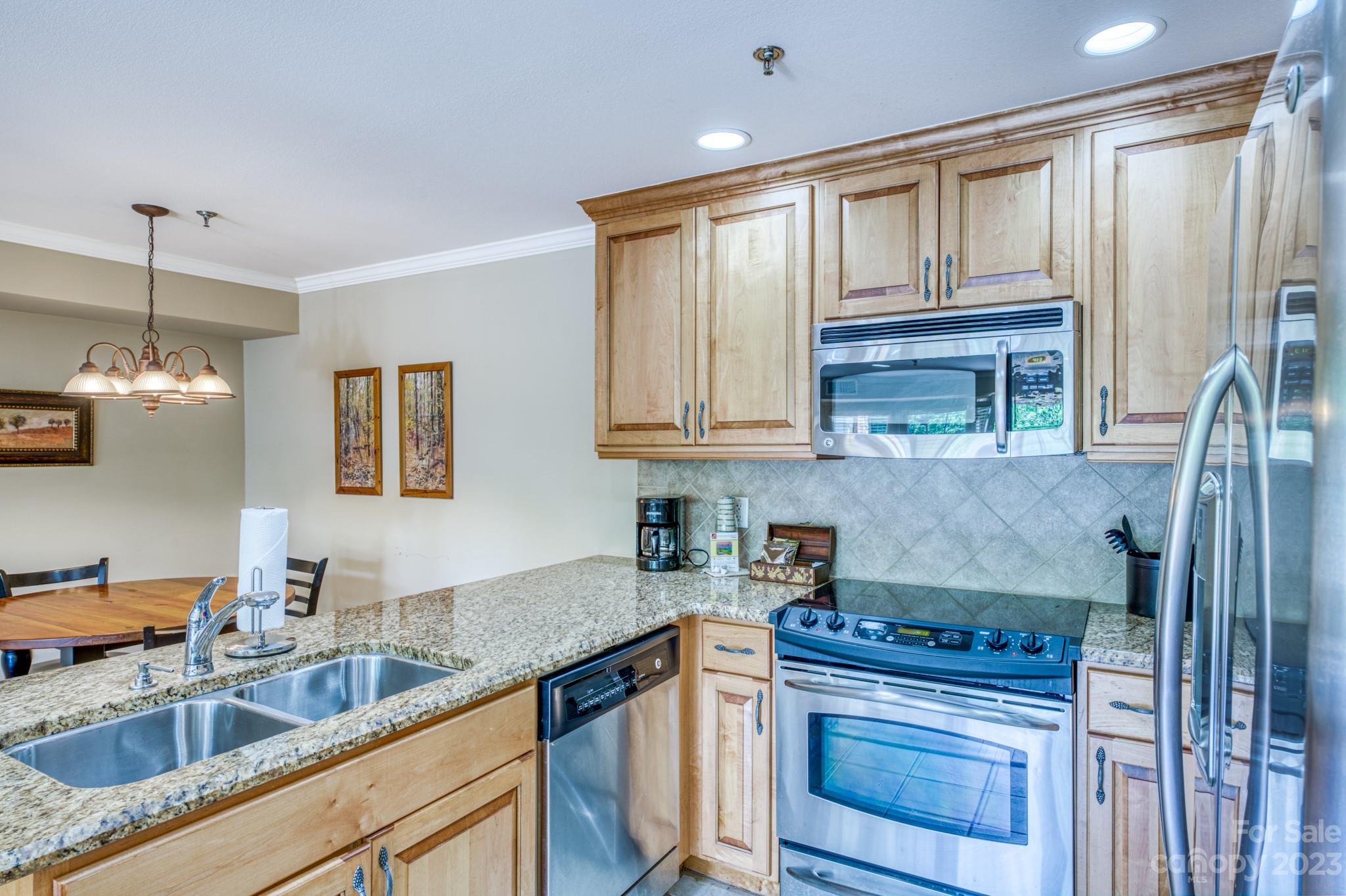 310 Bowling Park Road Asheville, NC 28803 - Photo 8 of 31 a kitchen with stainless steel appliances granite countertop a sink stove and refrigerator