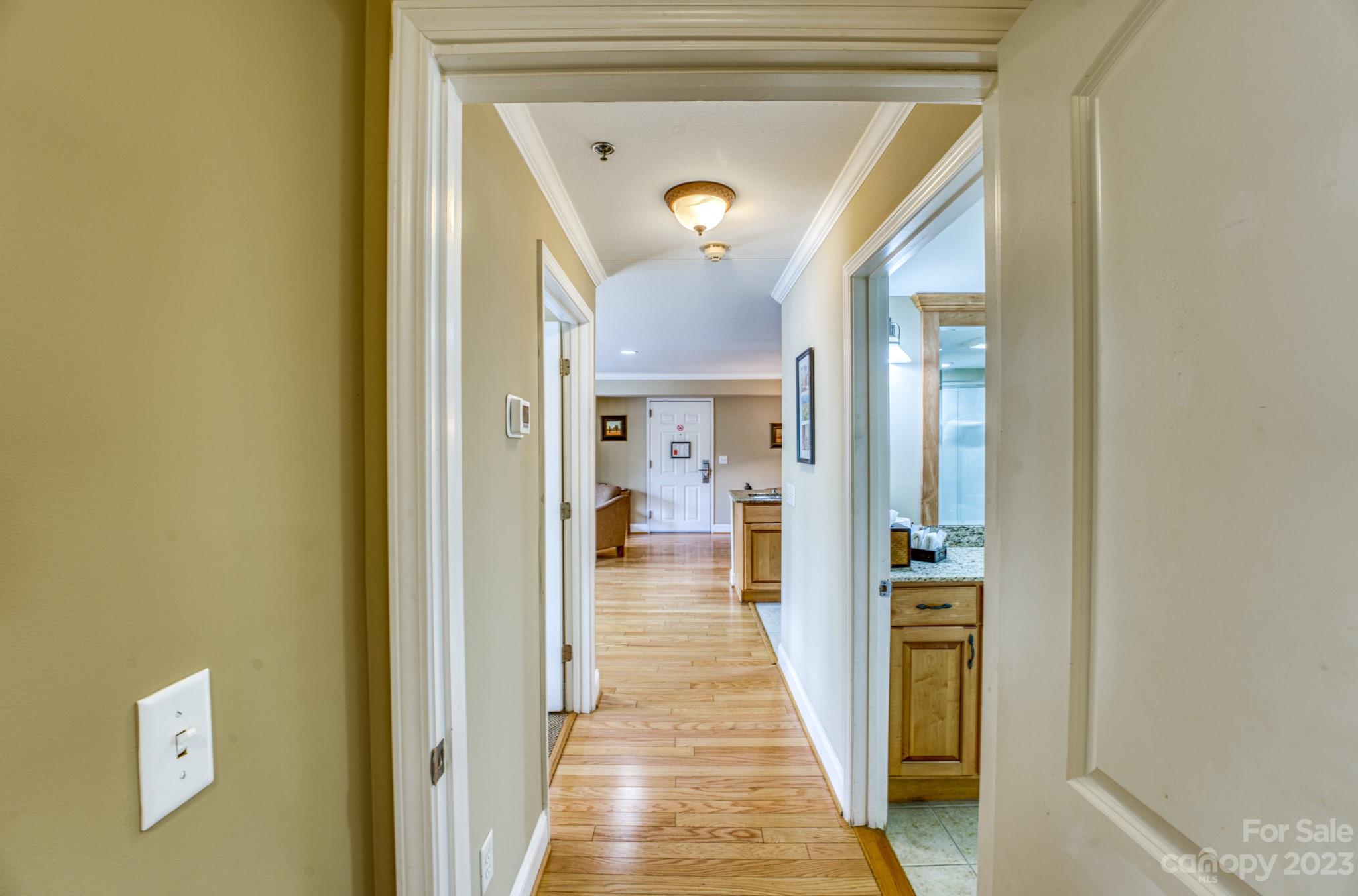 310 Bowling Park Road Asheville, NC 28803 - Photo 10 of 31 a view of a hallway with wooden floor and a living room