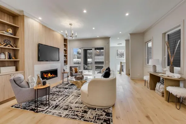 a living room with fireplace furniture and a flat screen tv
