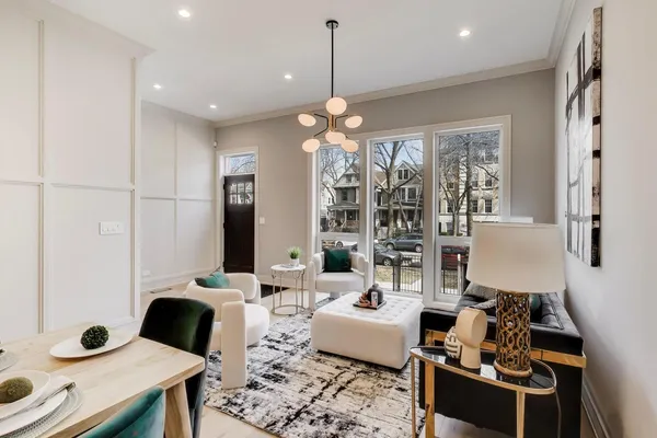a living room with furniture and a chandelier
