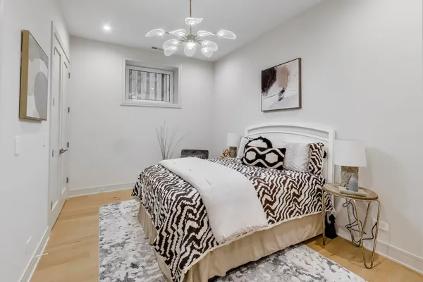 a bedroom with a bed and a chandelier