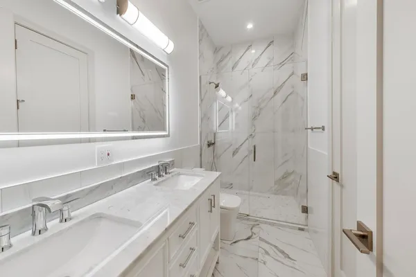 a bathroom with a granite countertop sink mirror and double