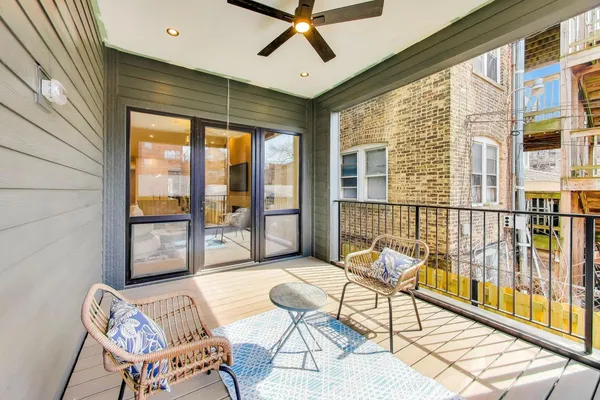 a living room with furniture and floor to ceiling windows