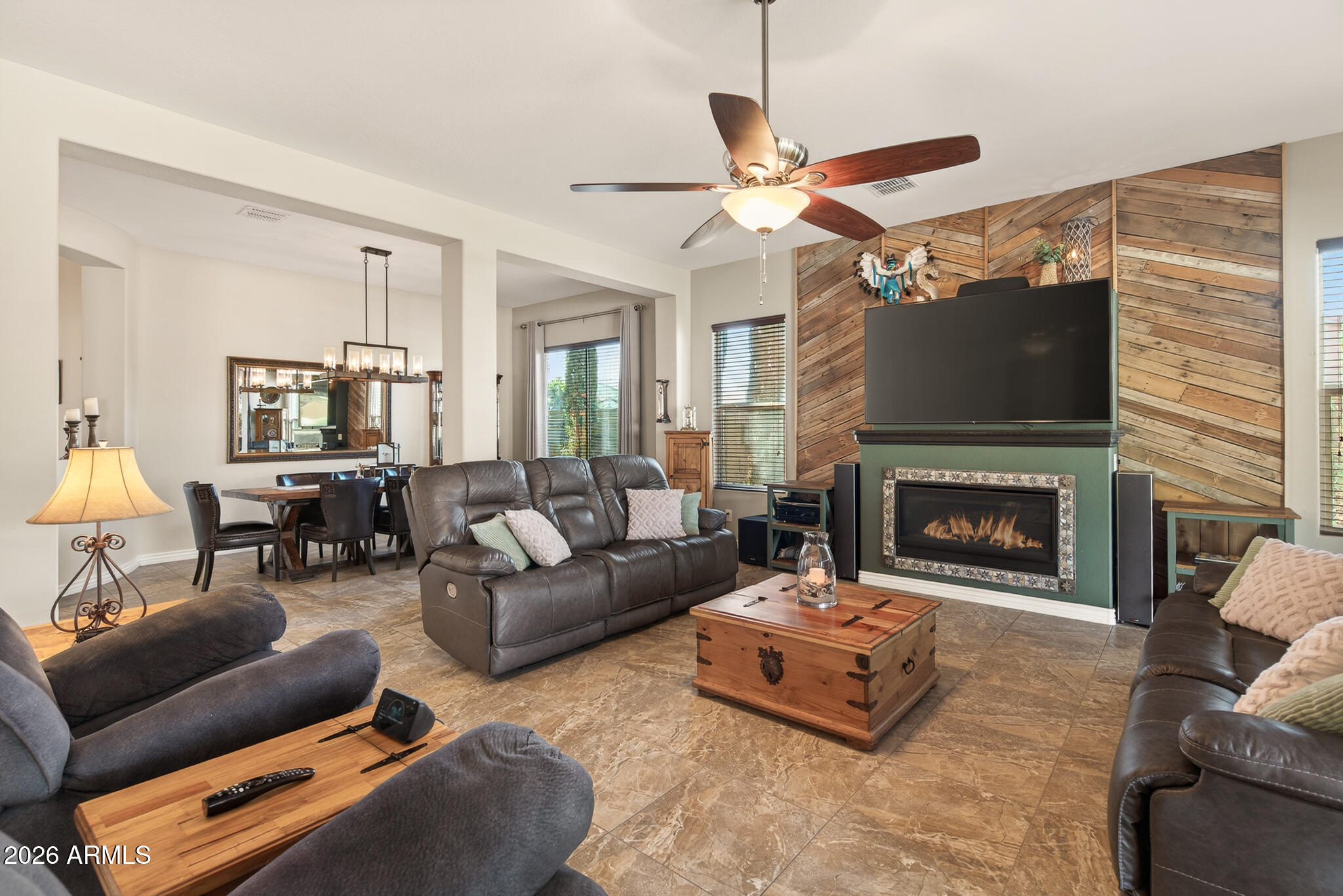 18398 West Rimrock Street Surprise, AZ 85388 - Photo 15 of 65 a living room with furniture a flat screen tv and a fireplace