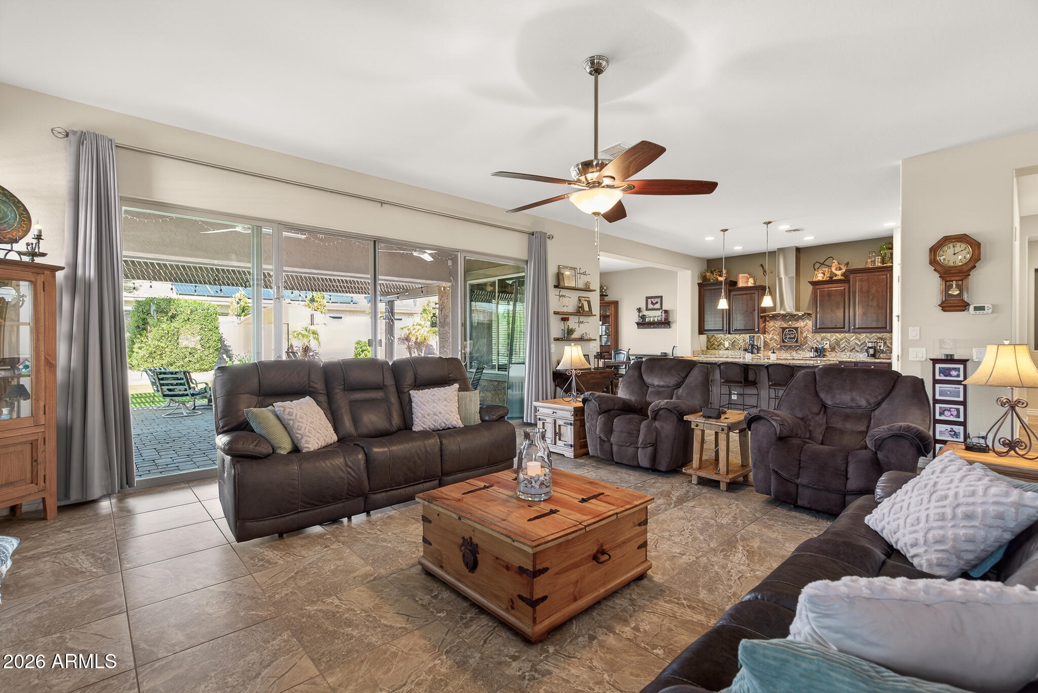 18398 West Rimrock Street Surprise, AZ 85388 - Photo 17 of 65 a living room with furniture a ceiling fan and a window