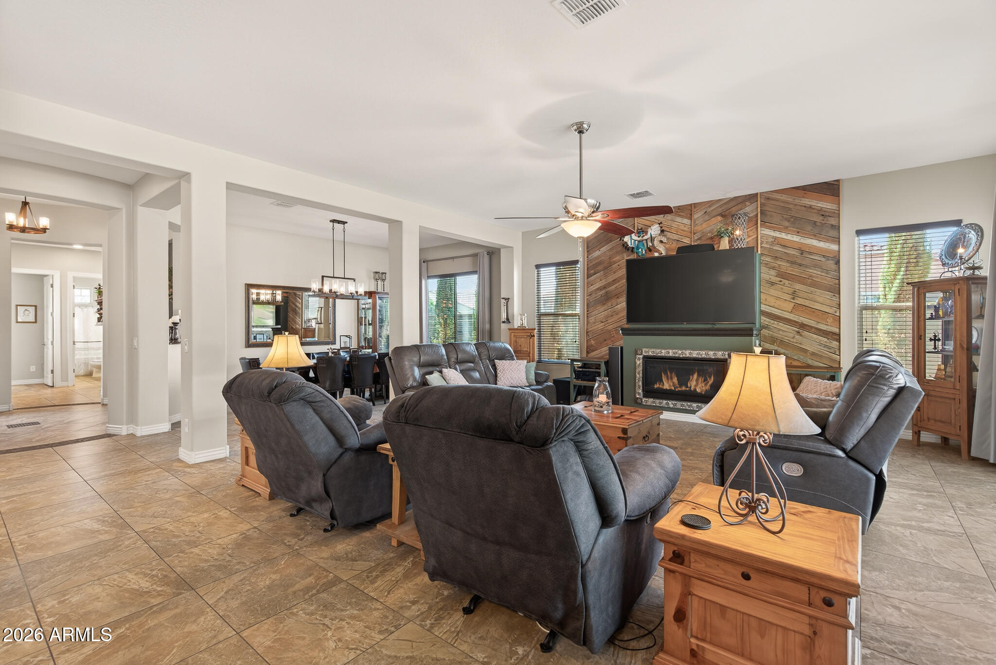 18398 West Rimrock Street Surprise, AZ 85388 - Photo 18 of 65 a living room with furniture a fireplace and a flat screen tv