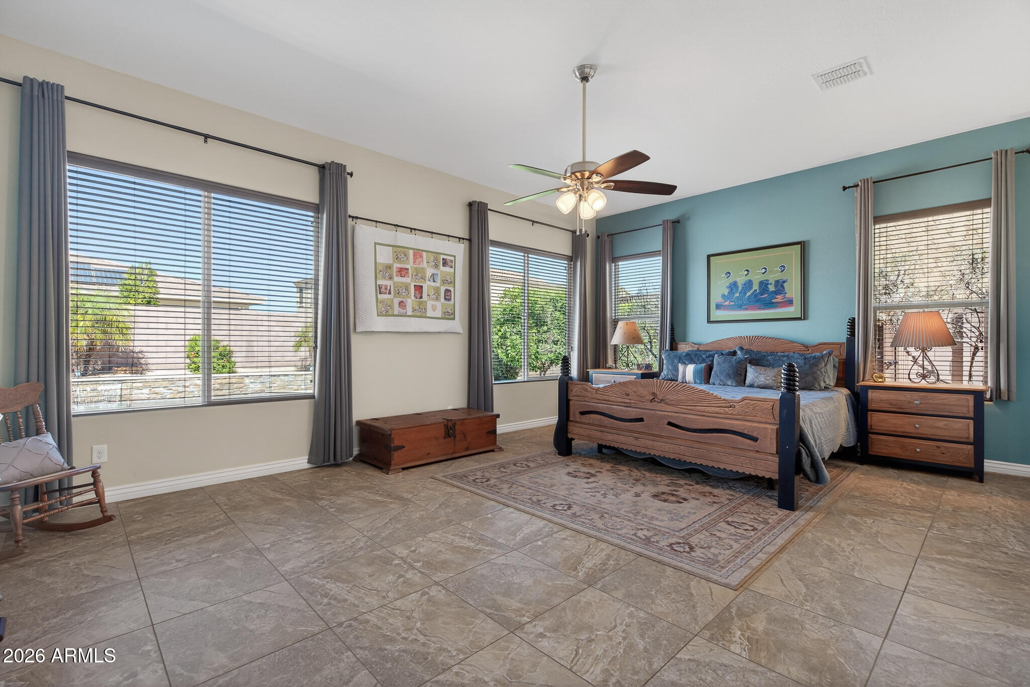 18398 West Rimrock Street Surprise, AZ 85388 - Photo 19 of 65 a spacious bedroom with a bed and a chandelier