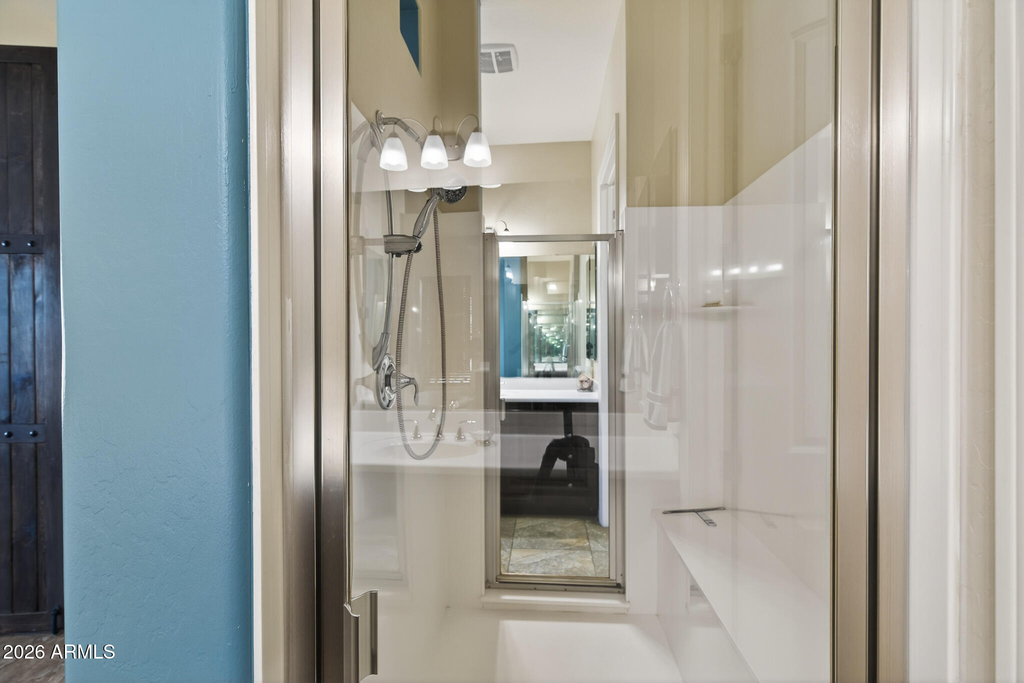 18398 West Rimrock Street Surprise, AZ 85388 - Photo 25 of 65 a bathroom with a glass shower door