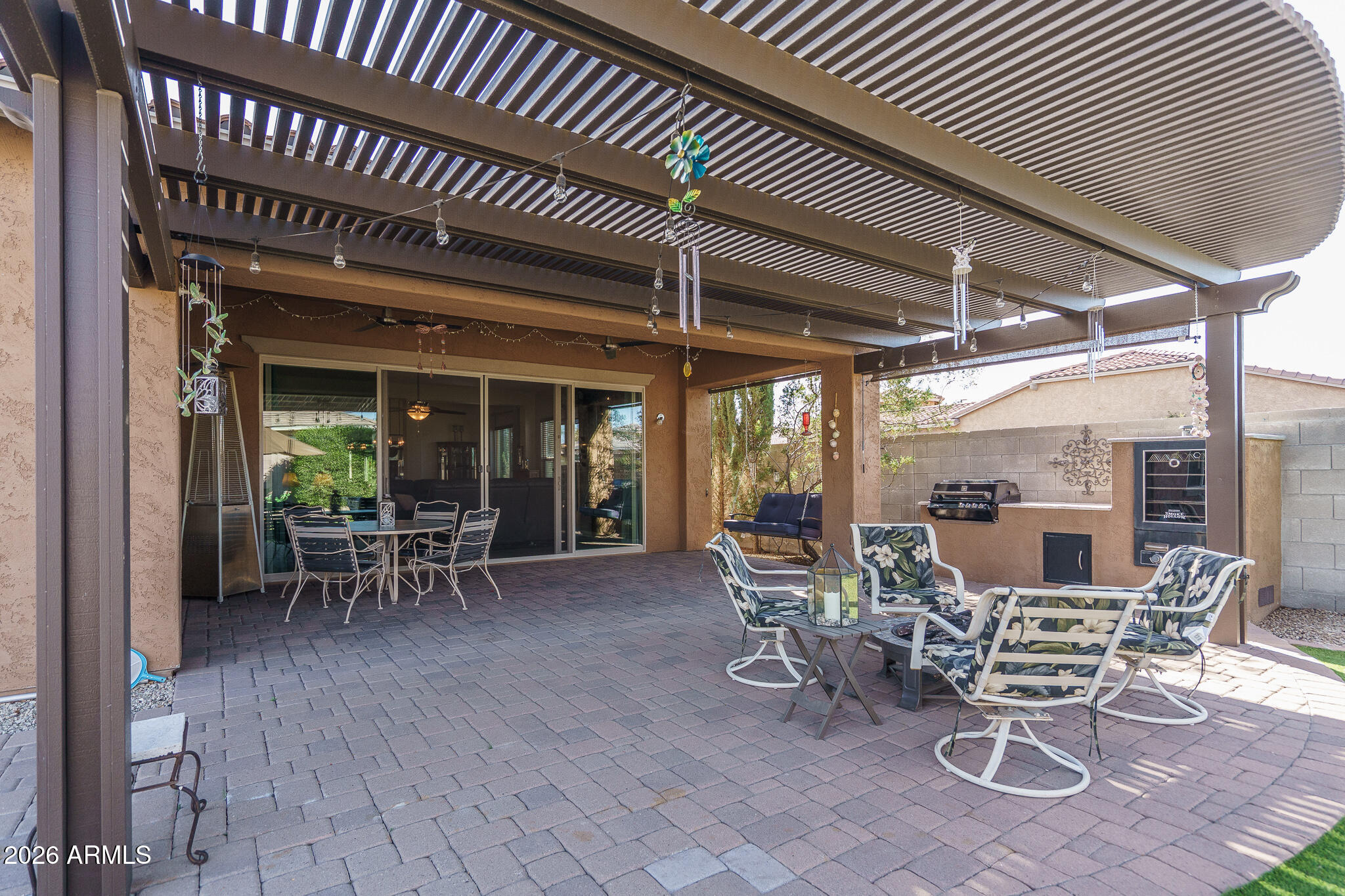 18398 West Rimrock Street Surprise, AZ 85388 - Photo 33 of 65 a view of a patio with table and chairs and floor to ceiling window