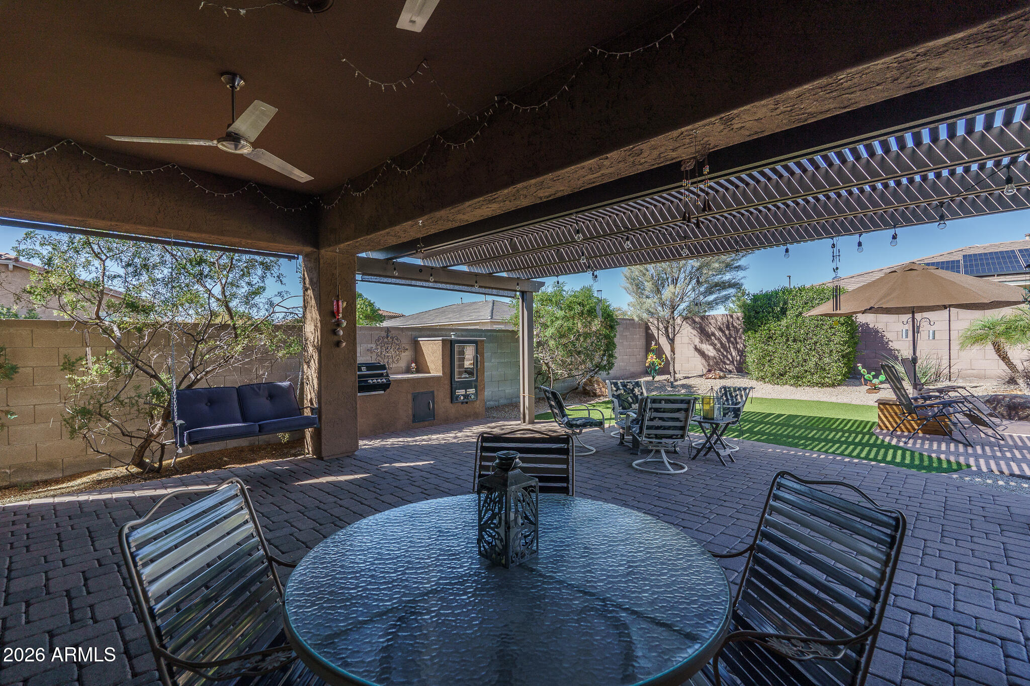 18398 West Rimrock Street Surprise, AZ 85388 - Photo 35 of 65 a view of a patio with table and chairs potted plants with floor to ceiling window