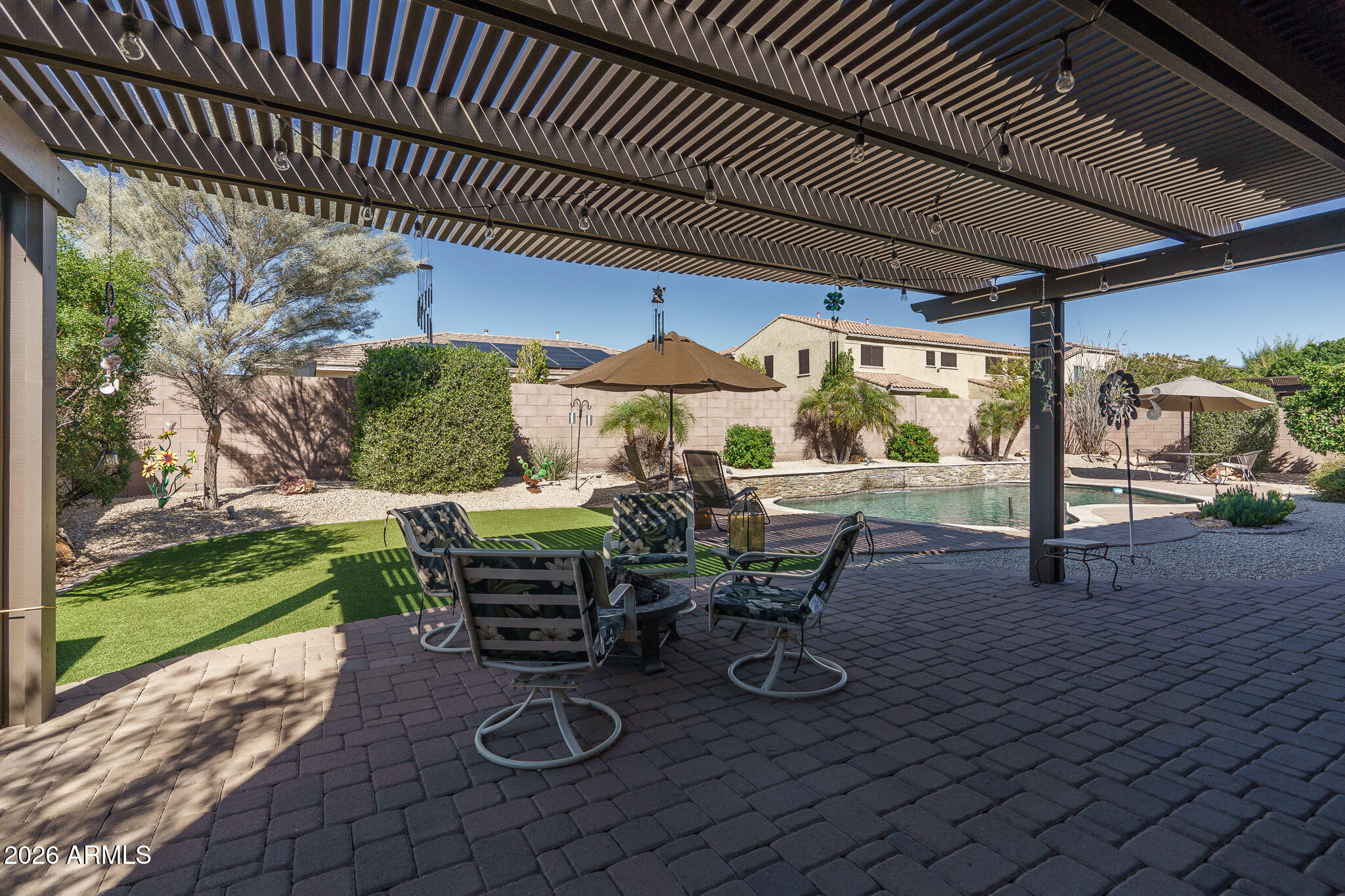 18398 West Rimrock Street Surprise, AZ 85388 - Photo 38 of 65 a view of a patio with chairs and table in patio