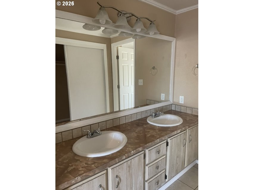5660 Daisy Street, Unit 31 Springfield, OR 97478 - Photo 23 of 44 a bathroom with a granite countertop sink and a mirror