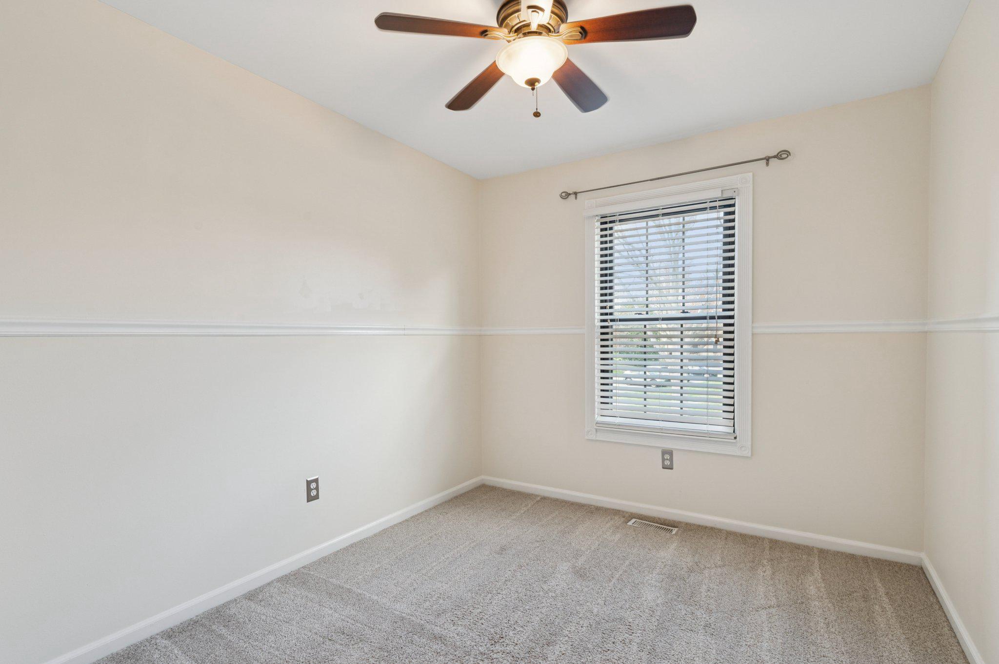 237 McIntosh Road, Unit 82 West Chester, PA 19382 - Photo 14 of 18 an empty room with a window and a fan
