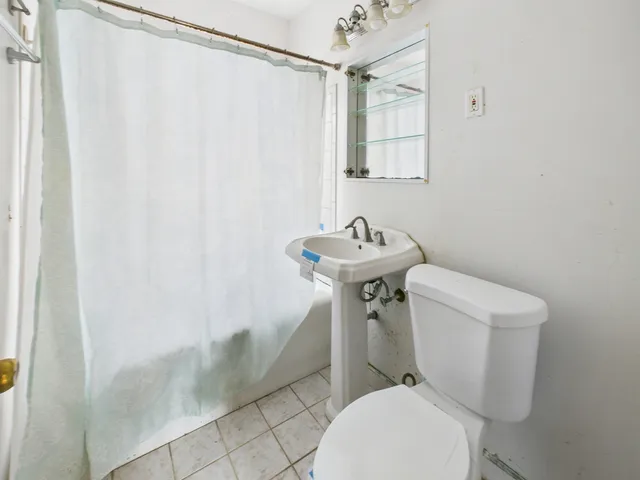 a white toilet sitting next to a bathroom sink
